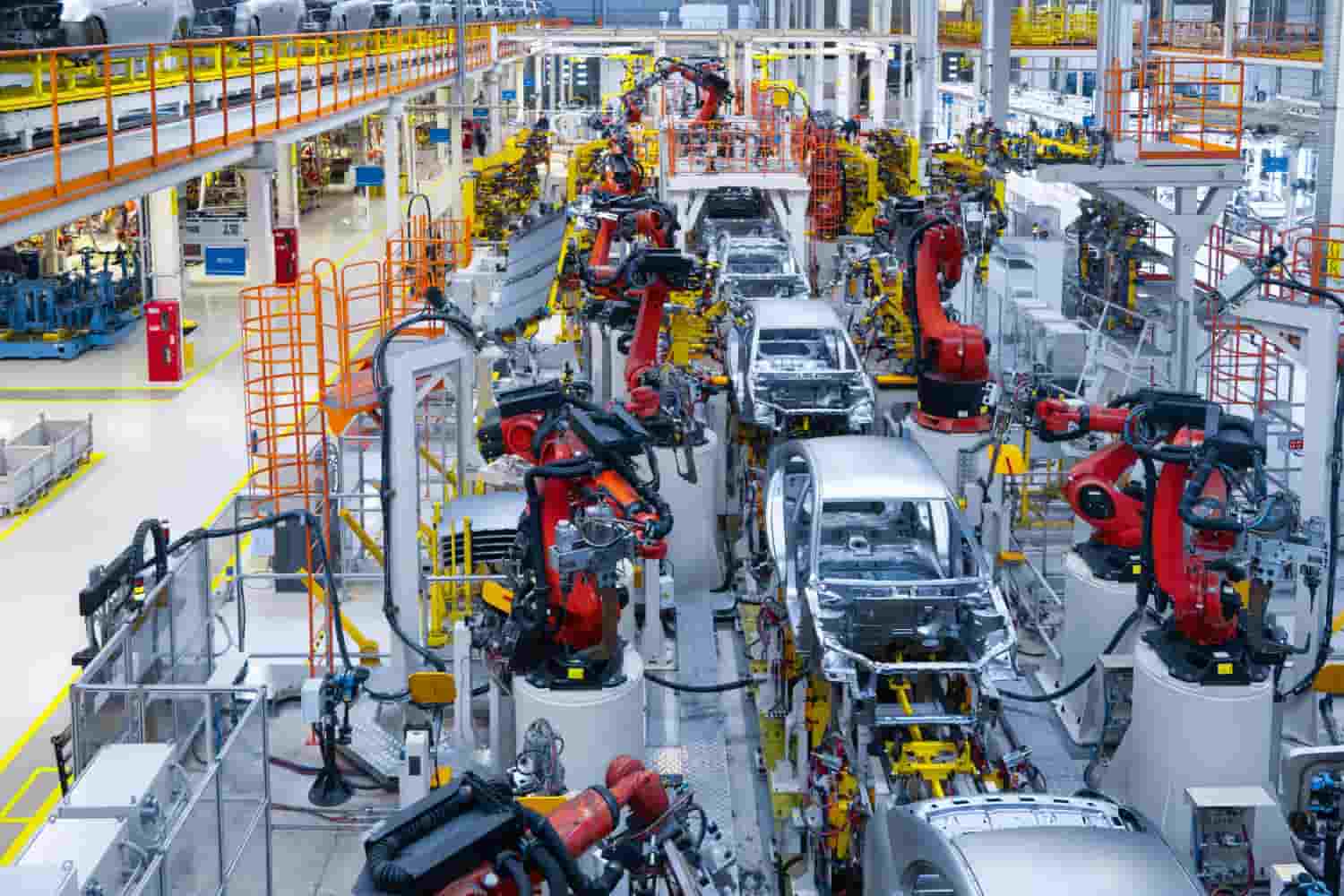 a factory with robots working on cars