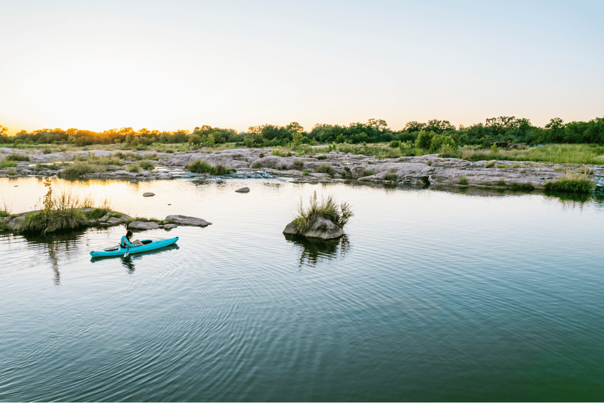 a person in a kayak on a river