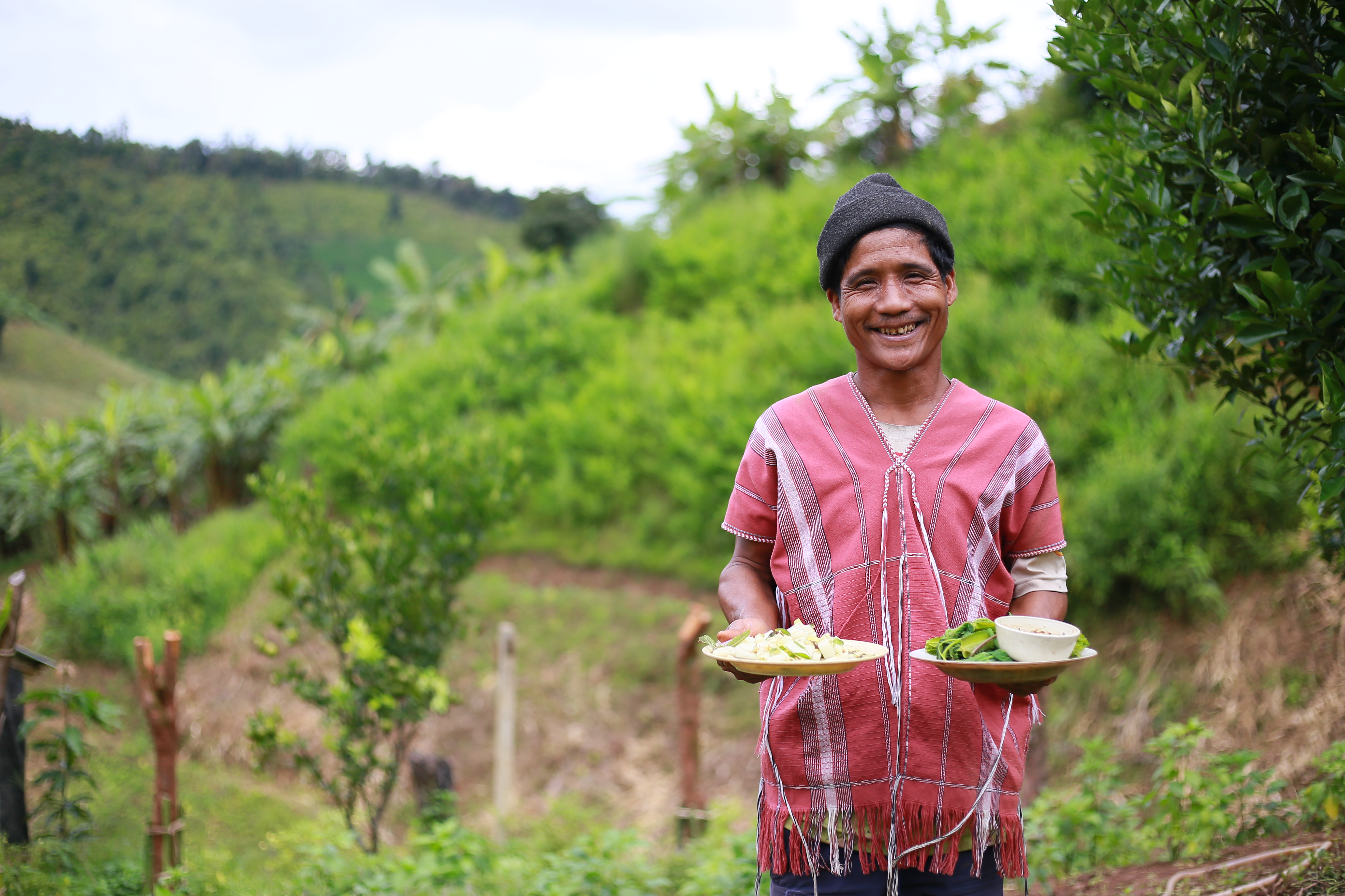 a man holding plates of food