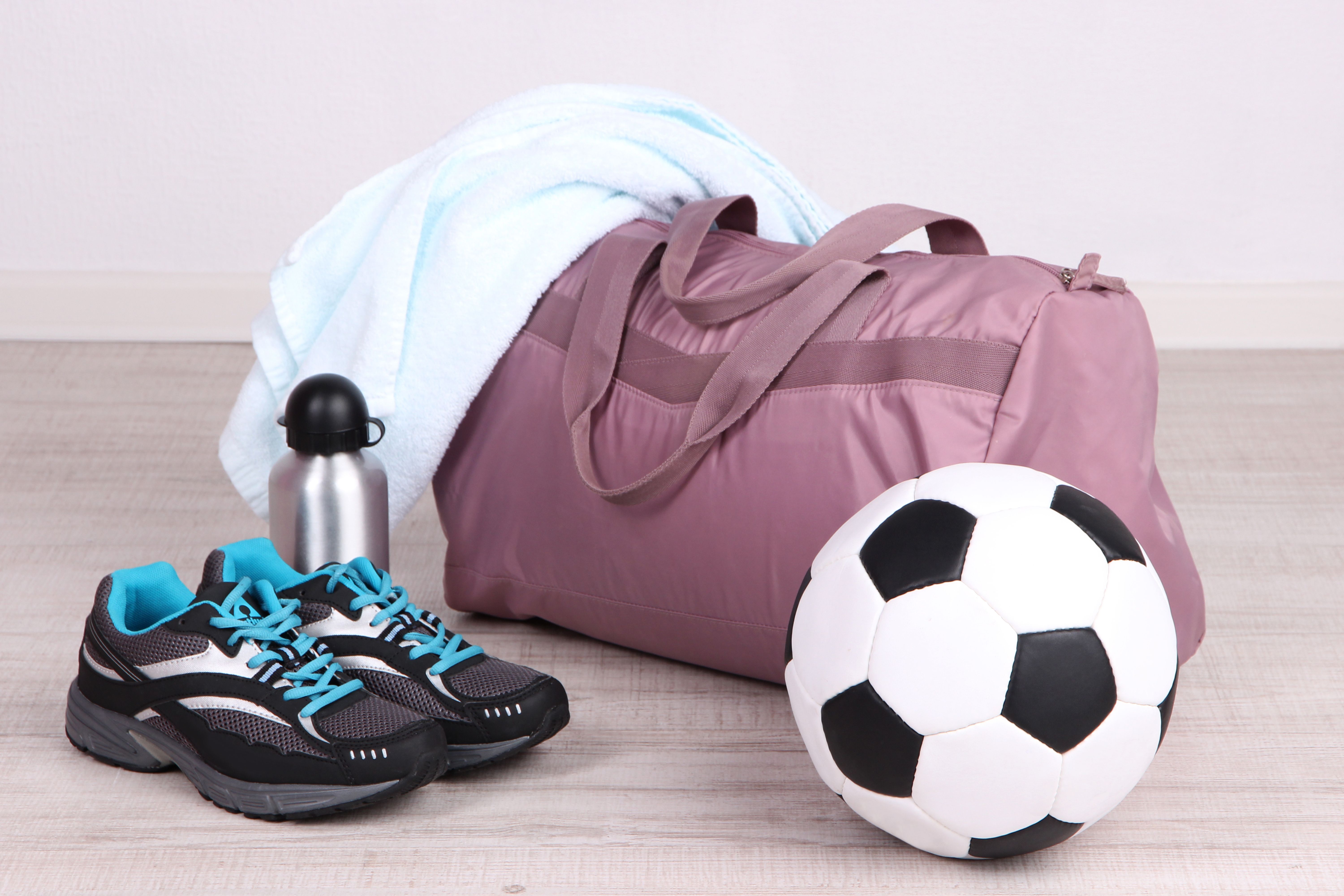 a bag with a towel and a football ball
