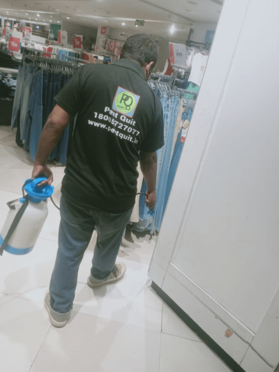 a man holding a sprayer in a store