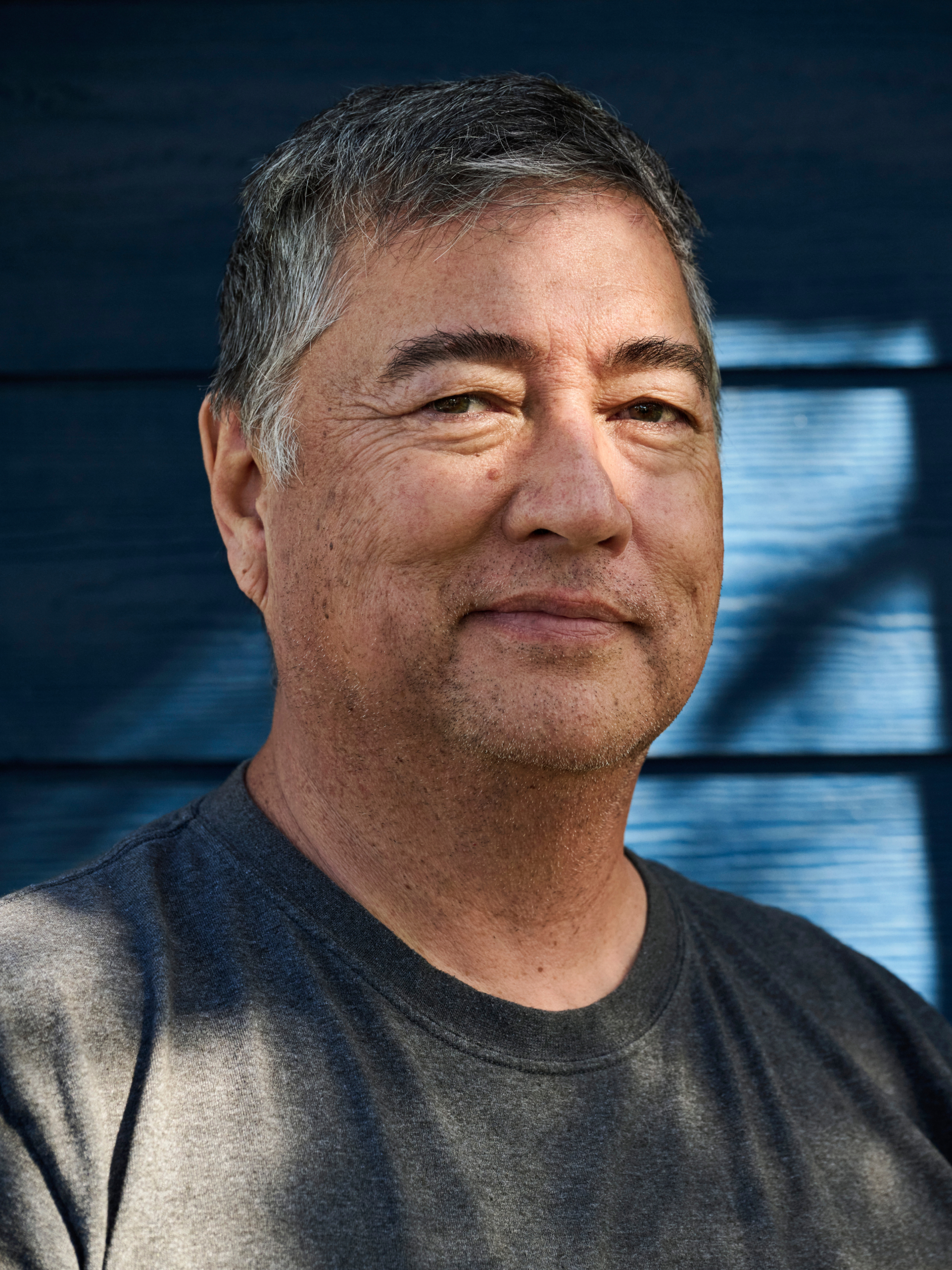 a man with grey hair and a black shirt