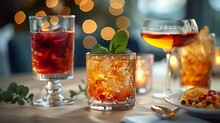 a group of glasses with ice and liquid on a table