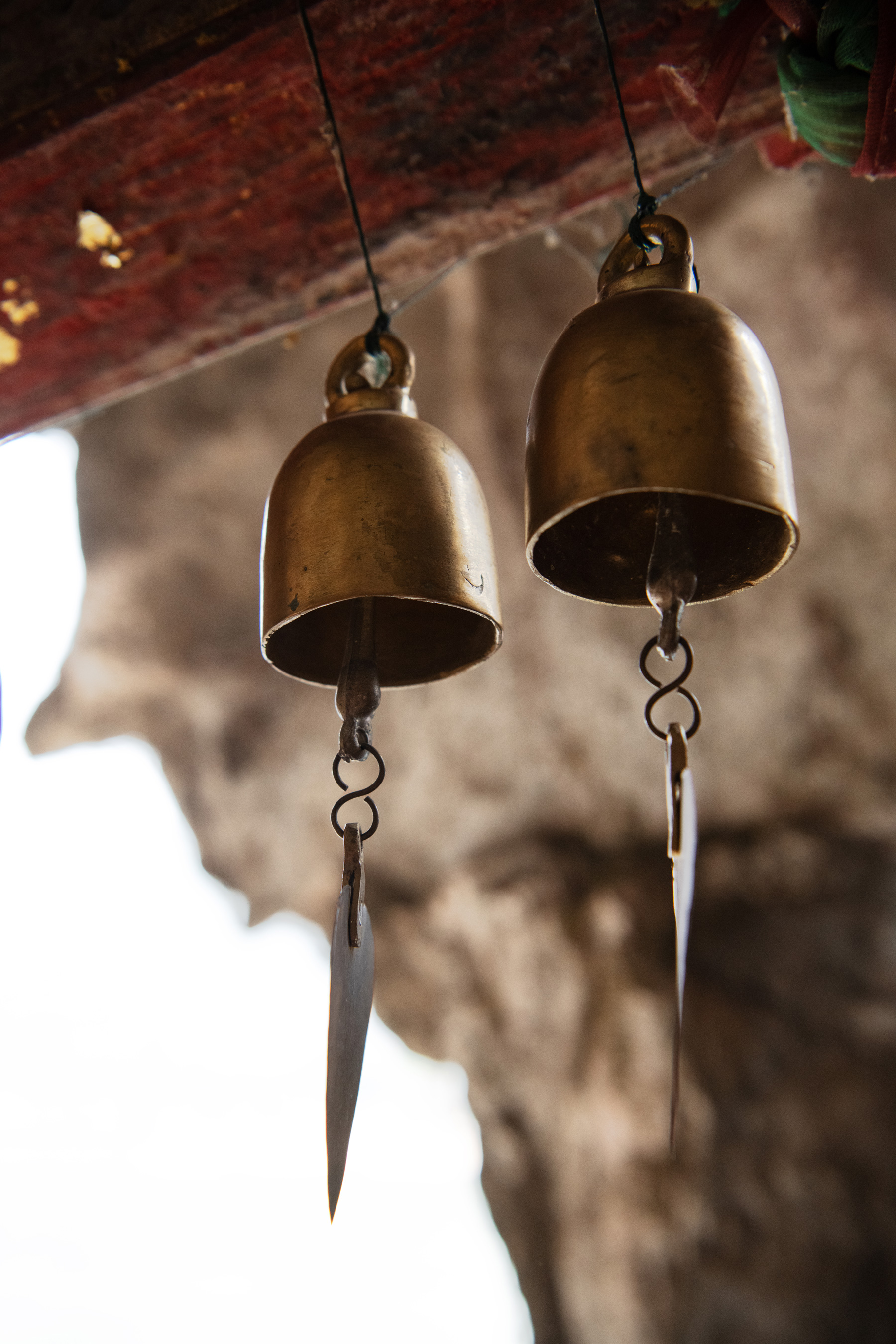 a pair of bells from a red beam