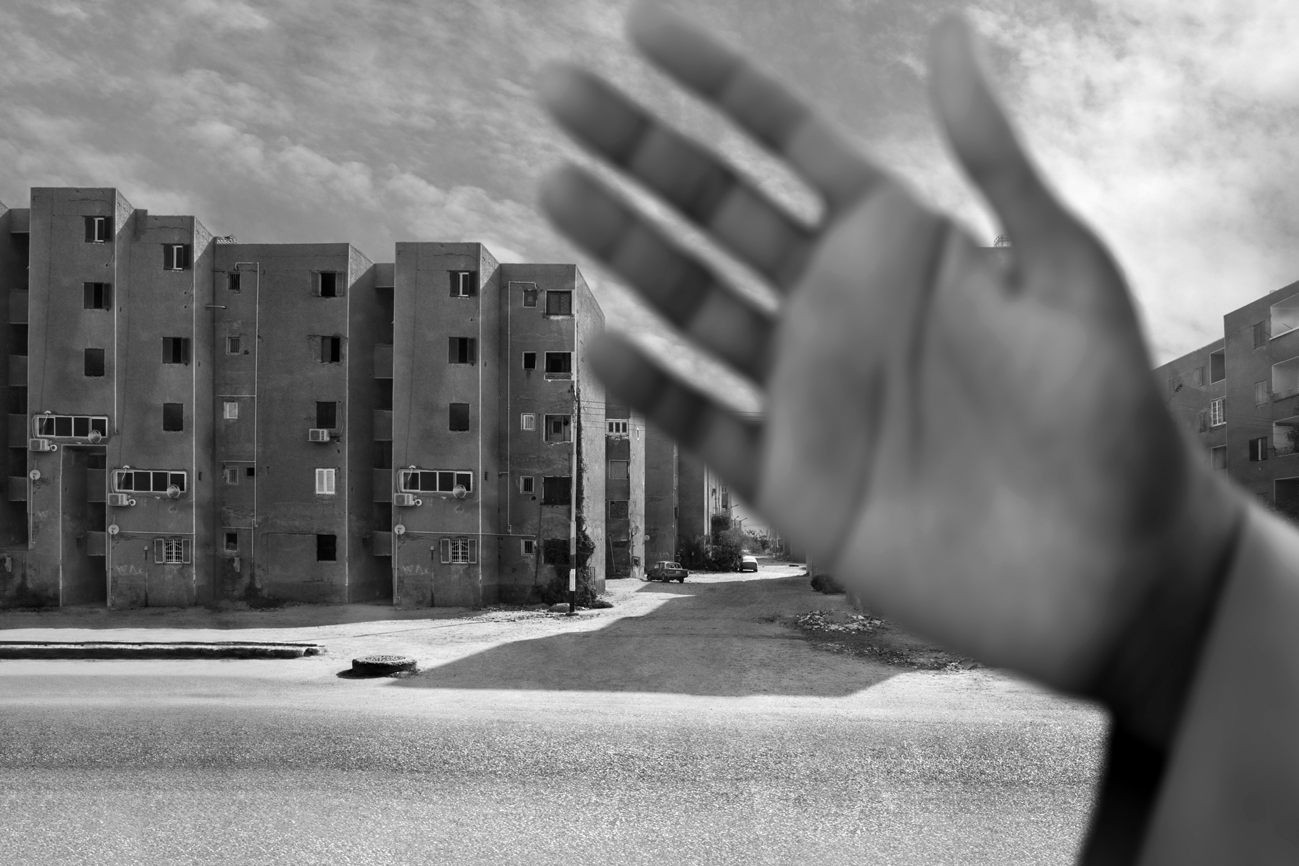 a hand reaching out to the side of a building