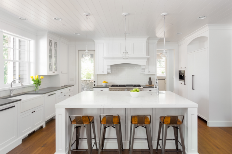 a white kitchen with a large island