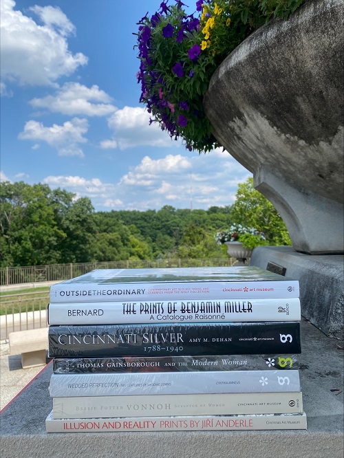 a stack of books on a concrete surface