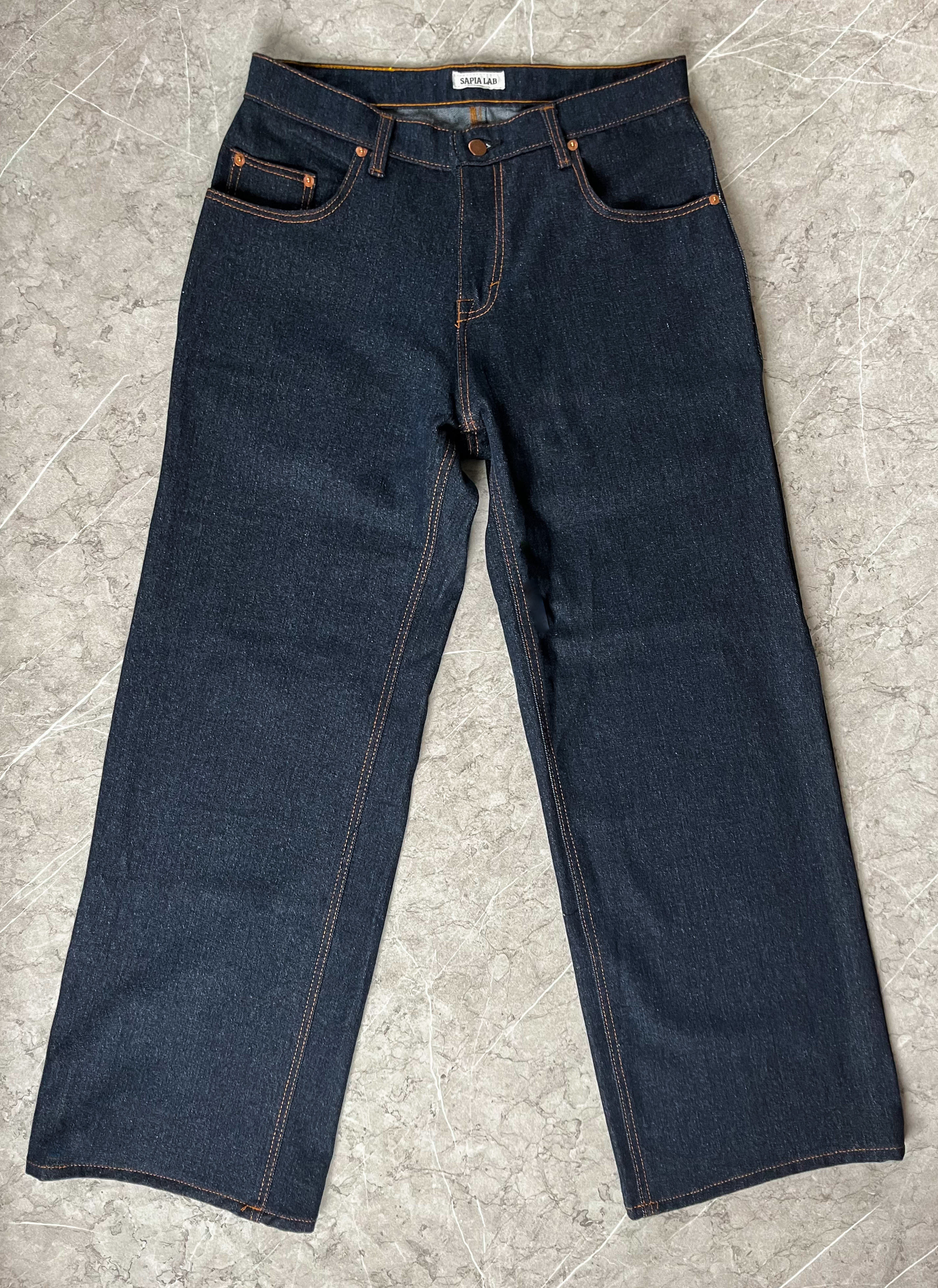 a pair of jeans on a grey surface