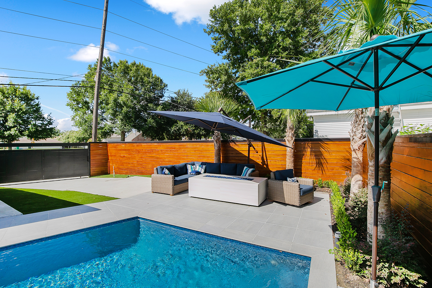 a pool with a couch and a umbrella