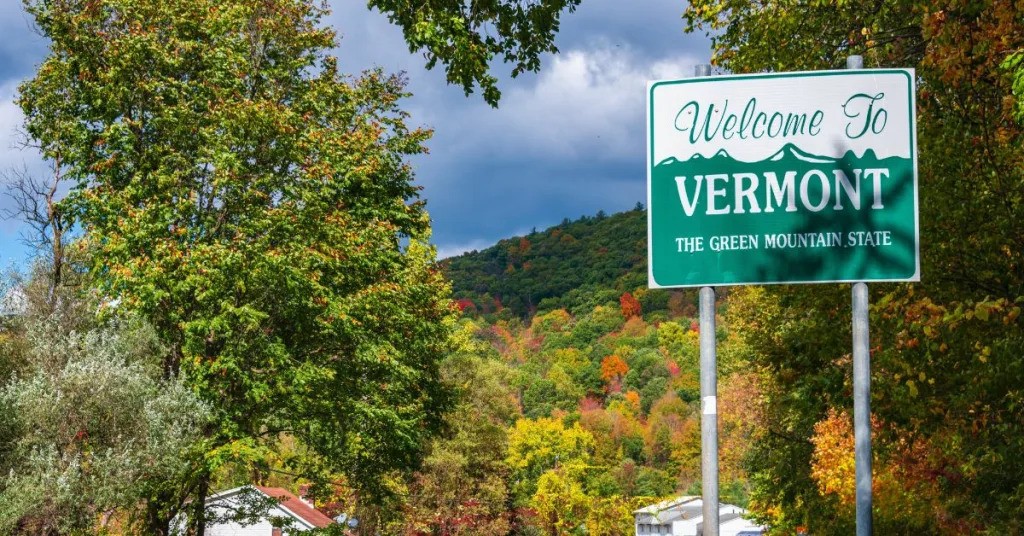 a sign with trees in the background