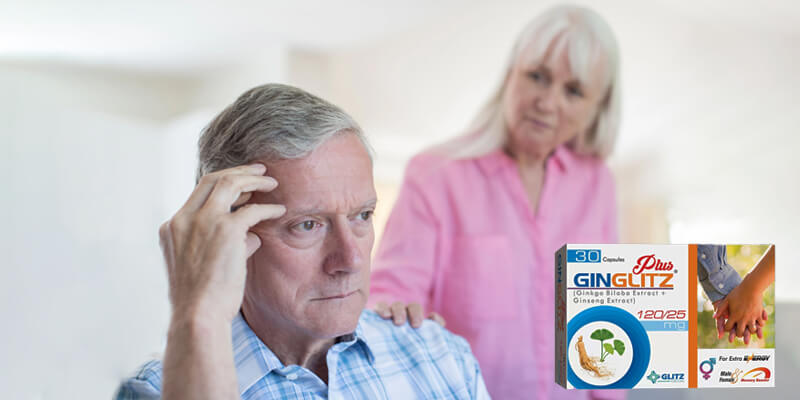 a man looking at a box of pills