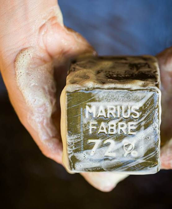 a person holding a soap cube