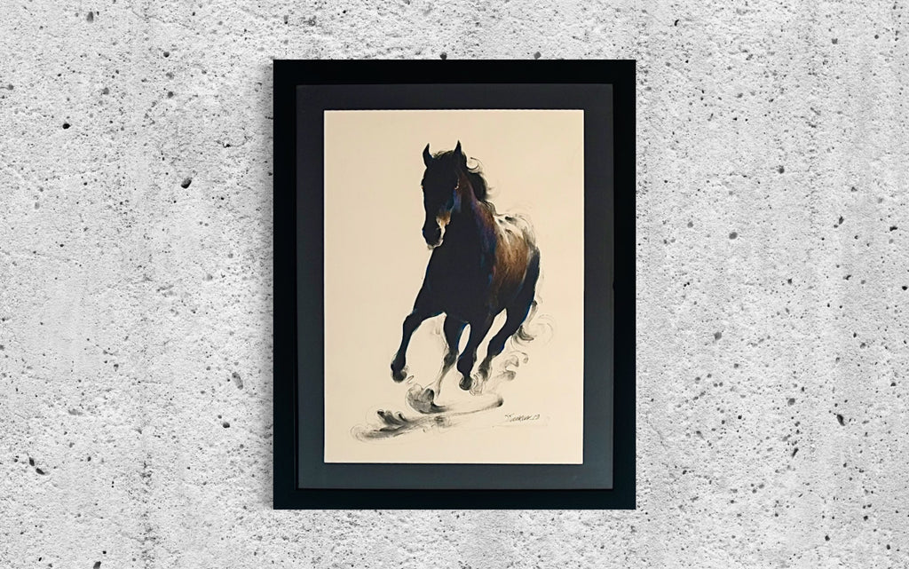 a picture of a horse in a black frame
