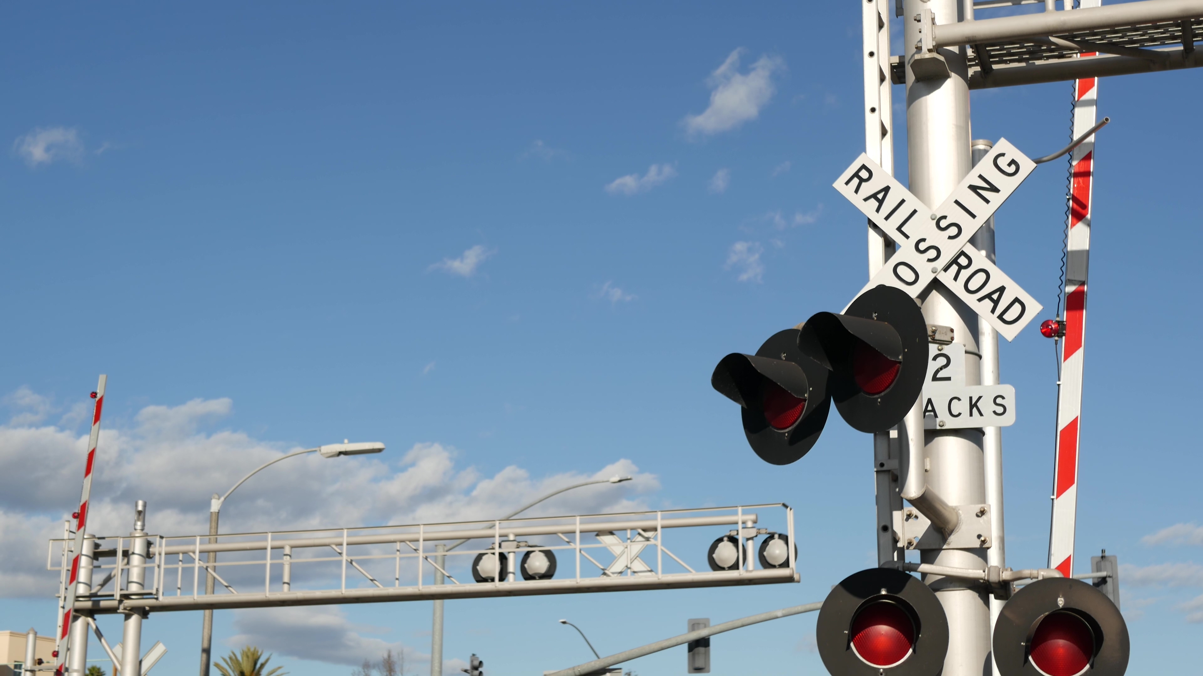 a train crossing lights and a sign