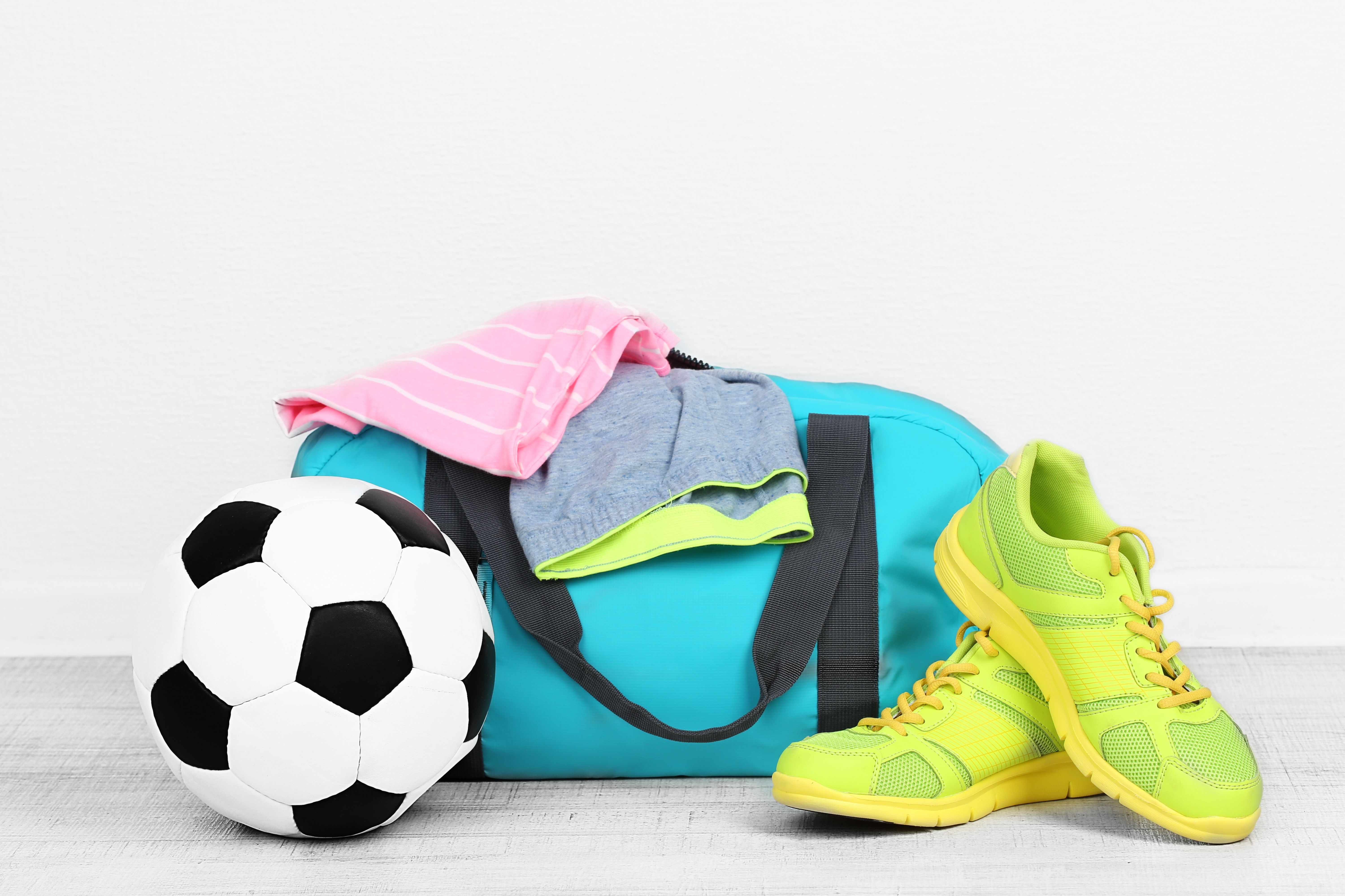 a bag with clothes and football ball