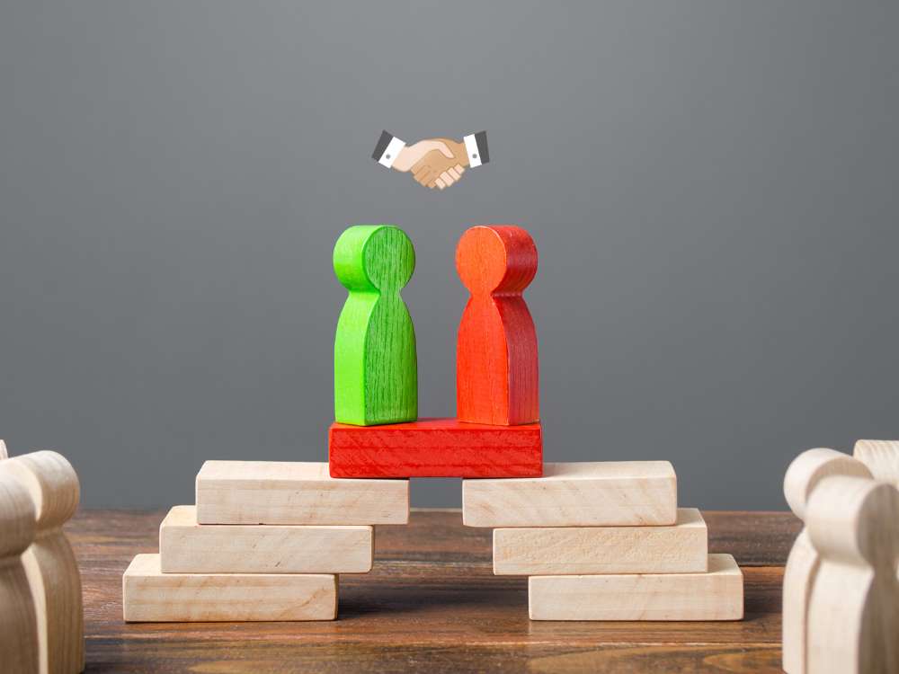 a red and green figures on a bridge
