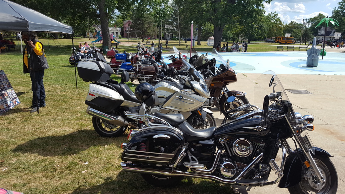 a group of motorcycles parked in a park