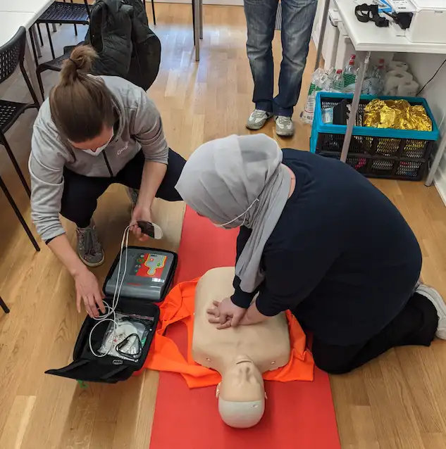 a group of people practicing cpr on a mannequin