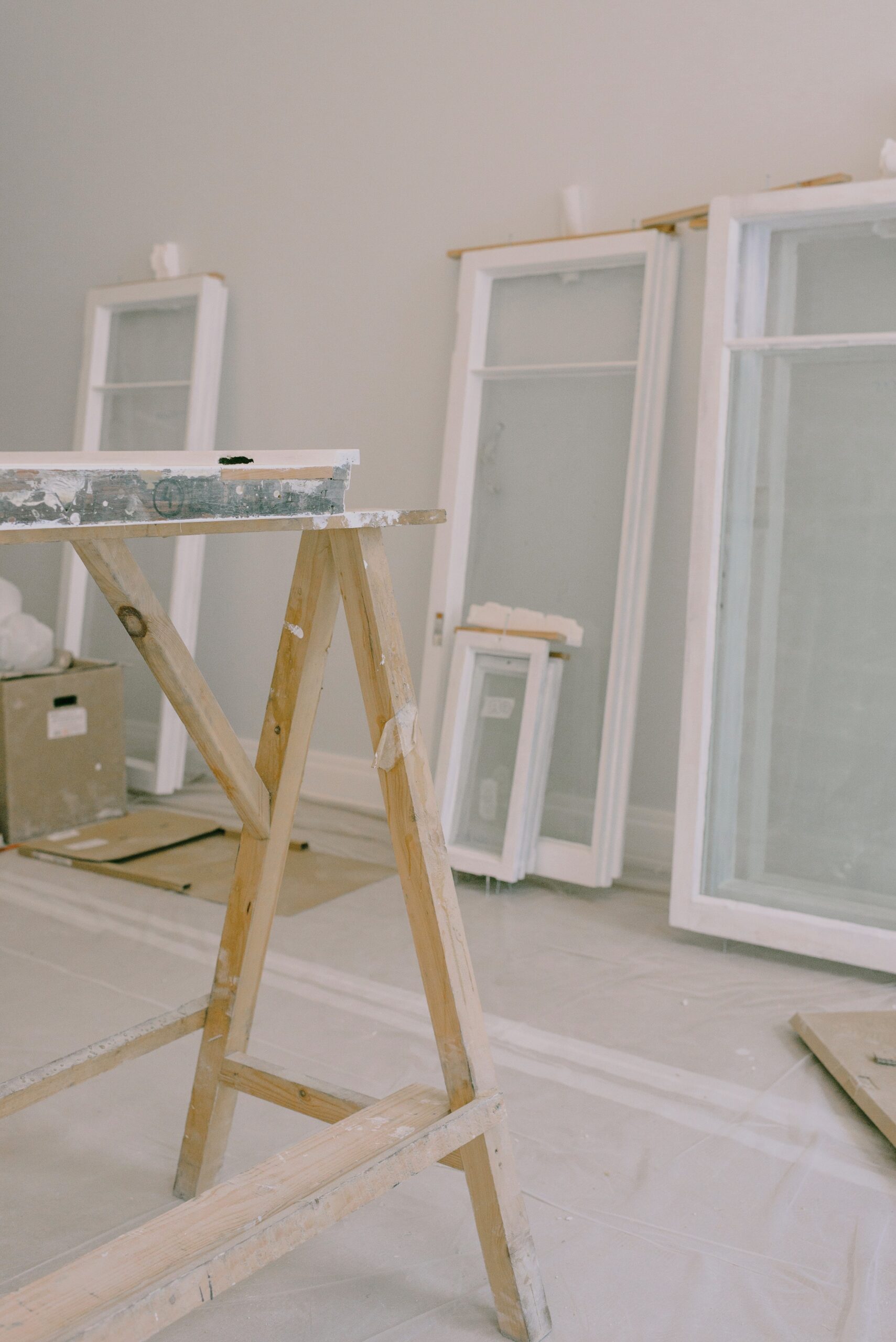 a wooden ladder in a room with windows