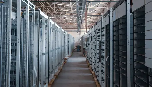 a room with many rows of computer servers