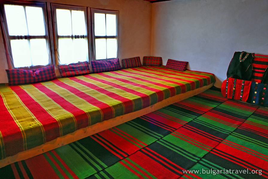 a bed with colorful blankets in a room