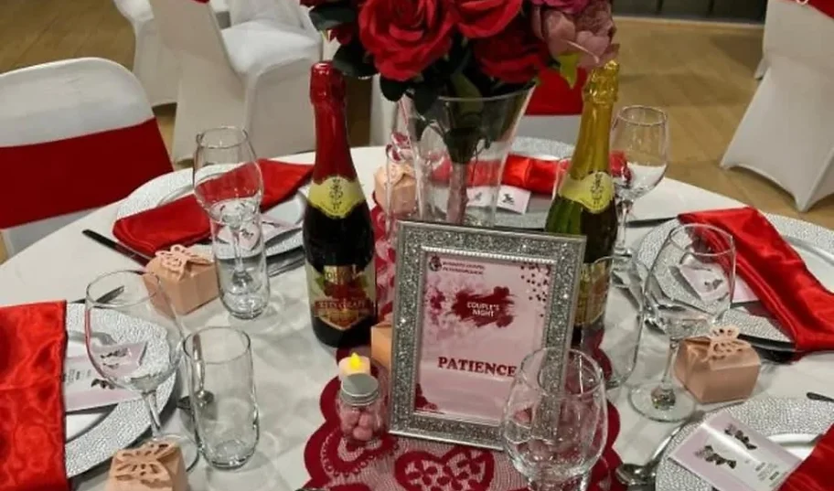 a table with wine glasses and a picture frame