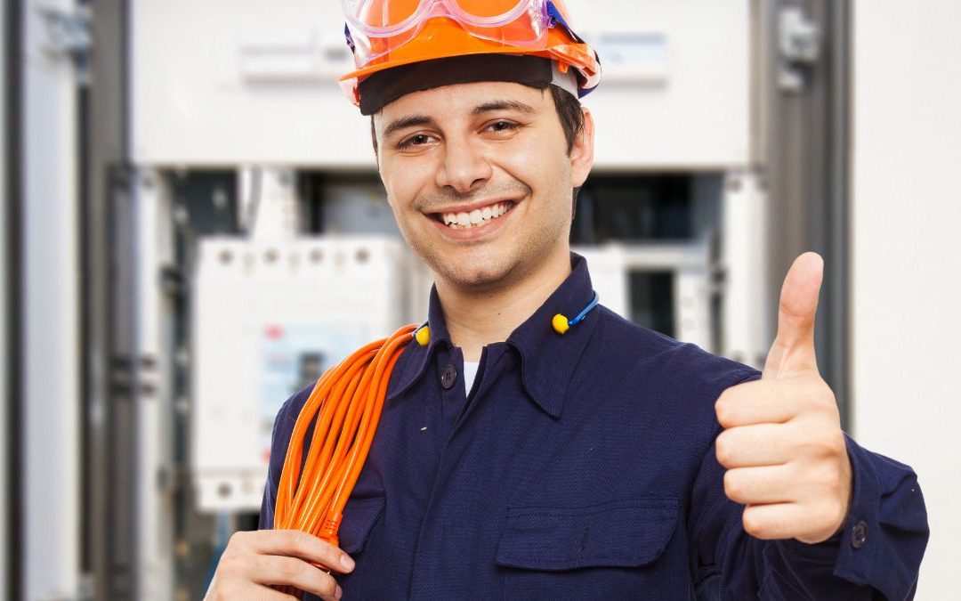 a man wearing a hard hat and holding a thumb up