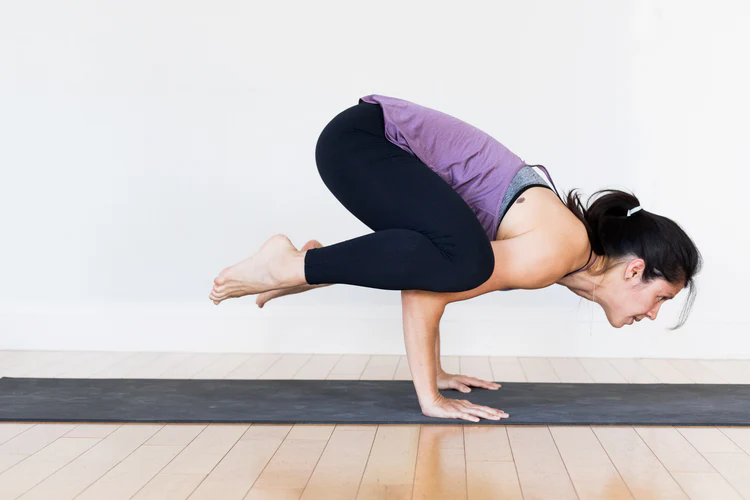 a woman doing yoga on a mat