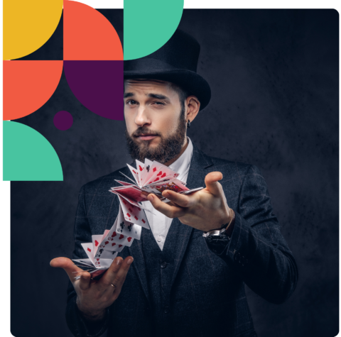 a man in a top hat and suit holding playing cards