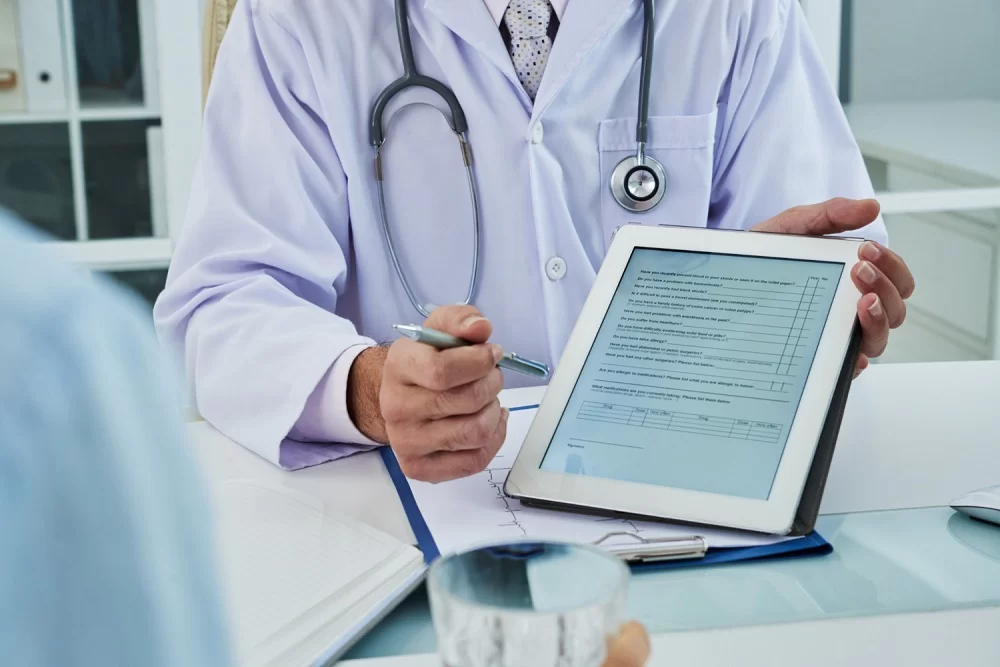 a doctor holding a tablet and pen