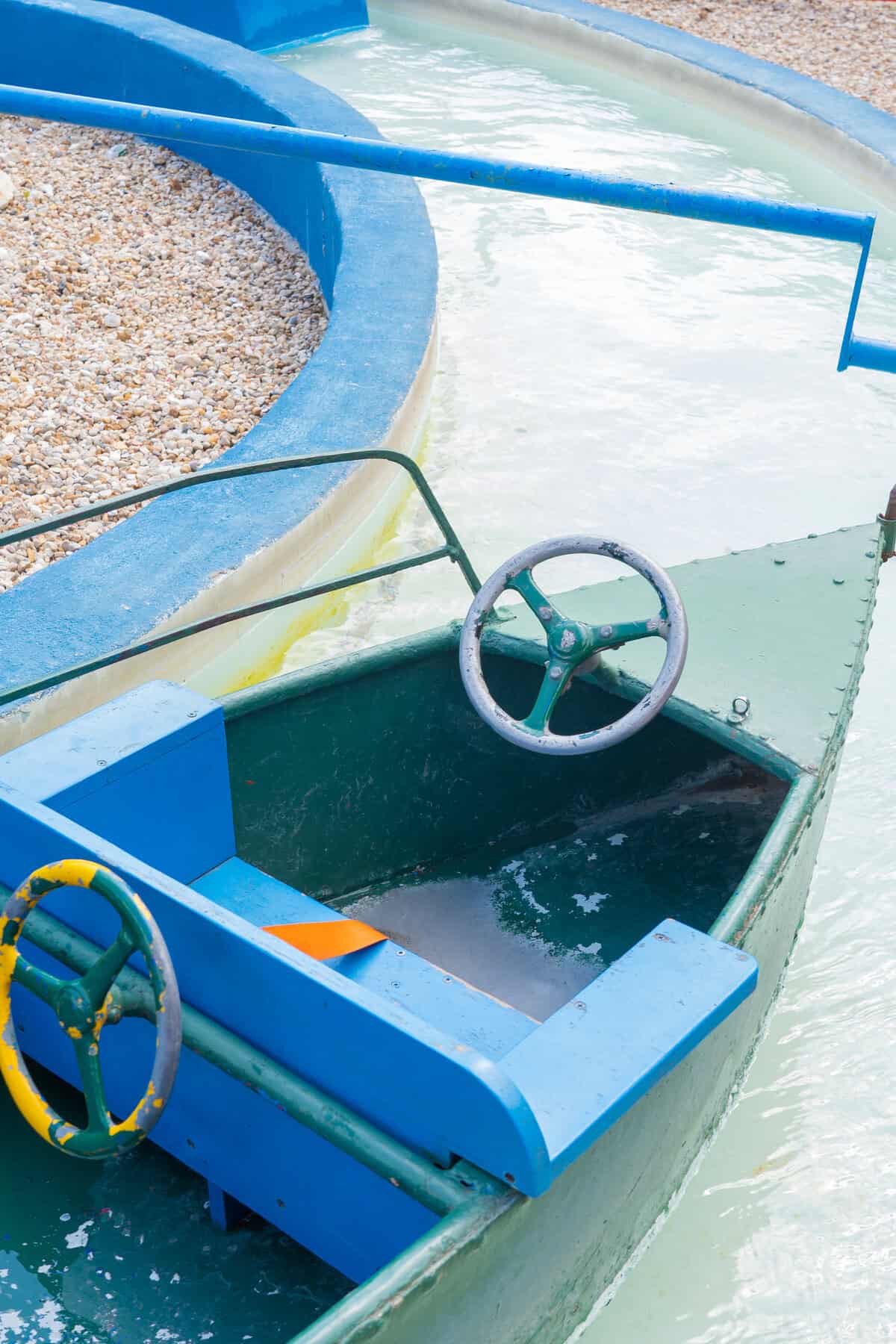 a boat with steering wheel on water