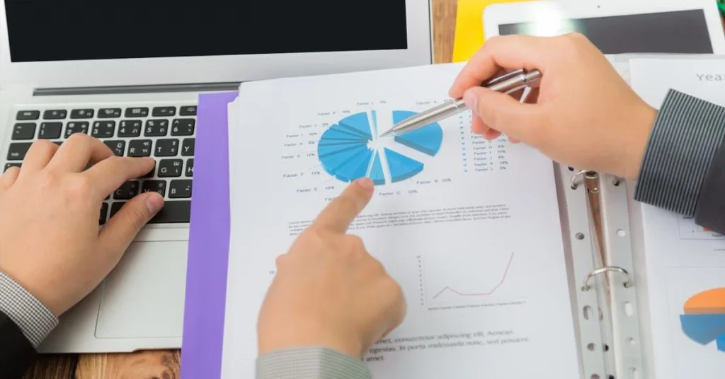 a person pointing at a pie chart