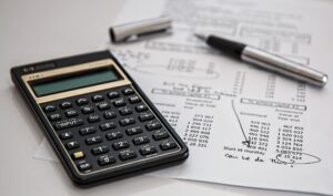 a calculator and pen on a paper