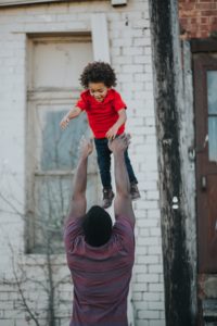 a man lifting a child up