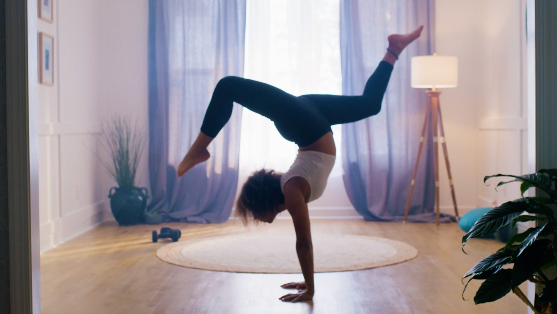 a woman doing a handstand in a room