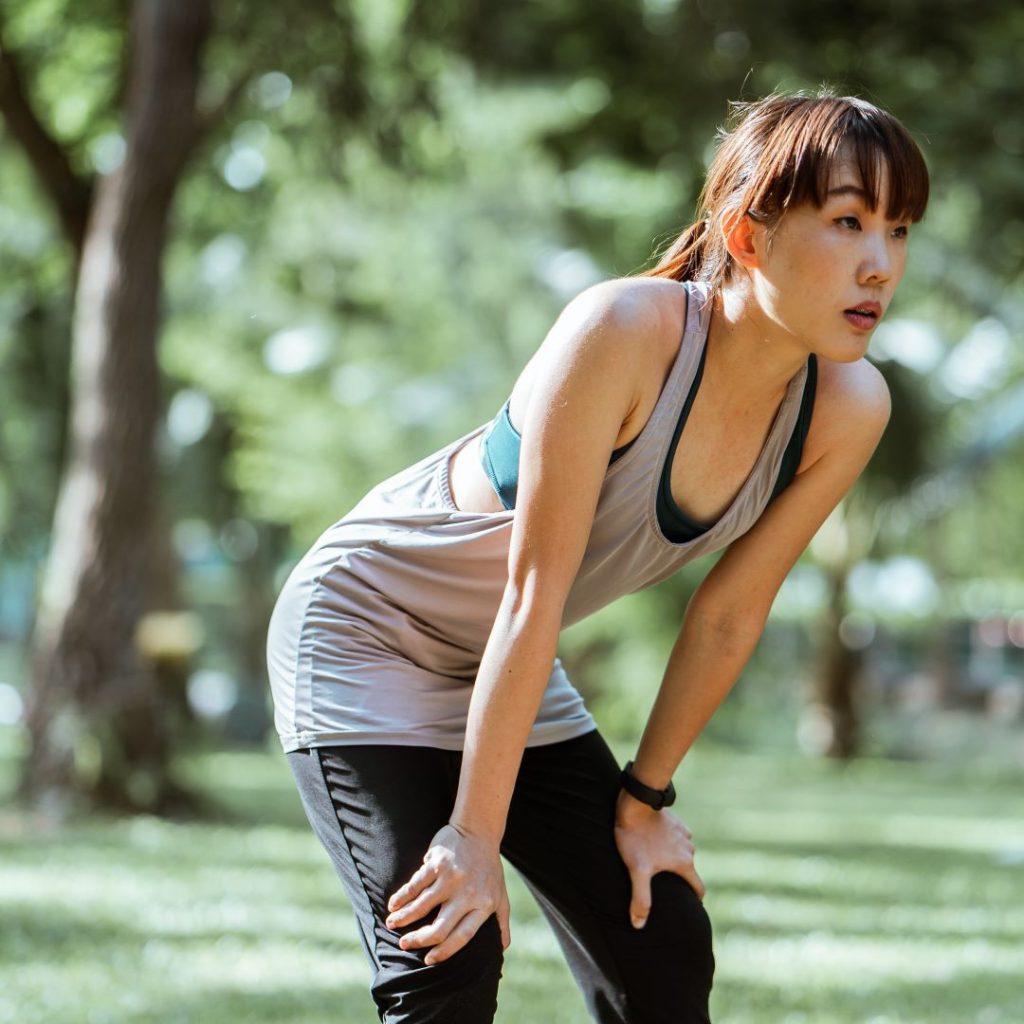 a woman stretching in a park