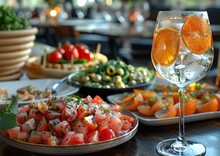 a table with plates of food and a glass of wine