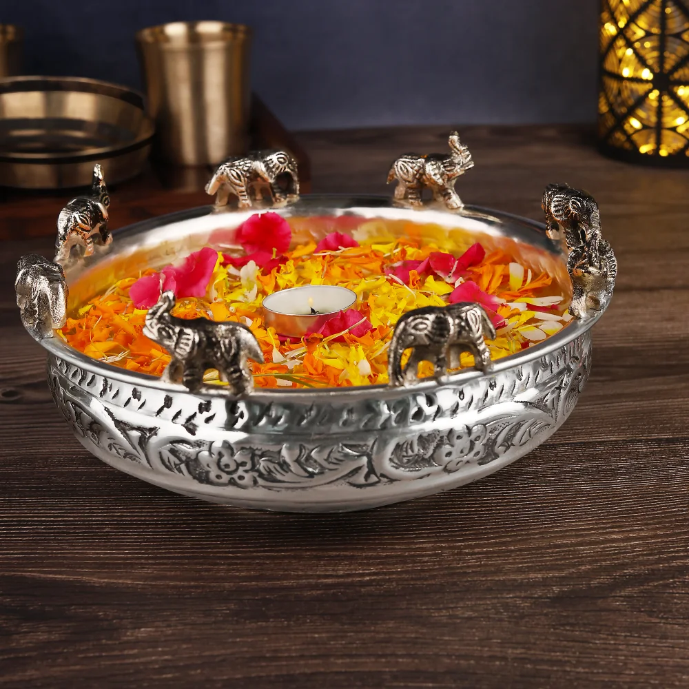 a bowl with flowers and candles