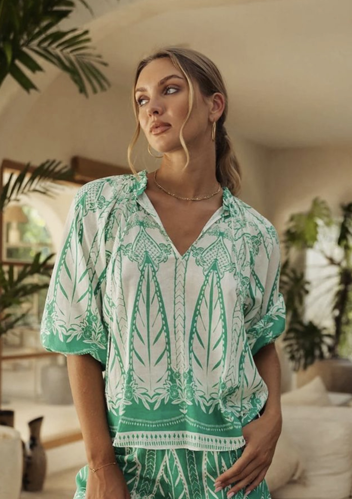 a woman in a green and white shirt