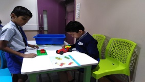 a boy playing with a toy car