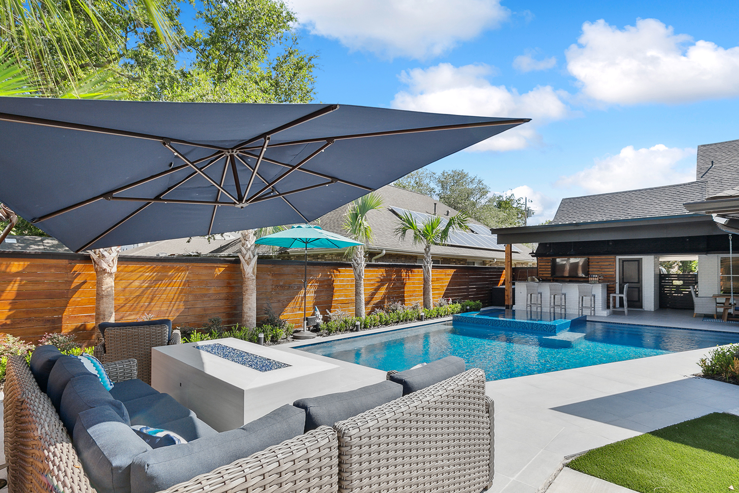 a pool with a bar and a bar and a patio area