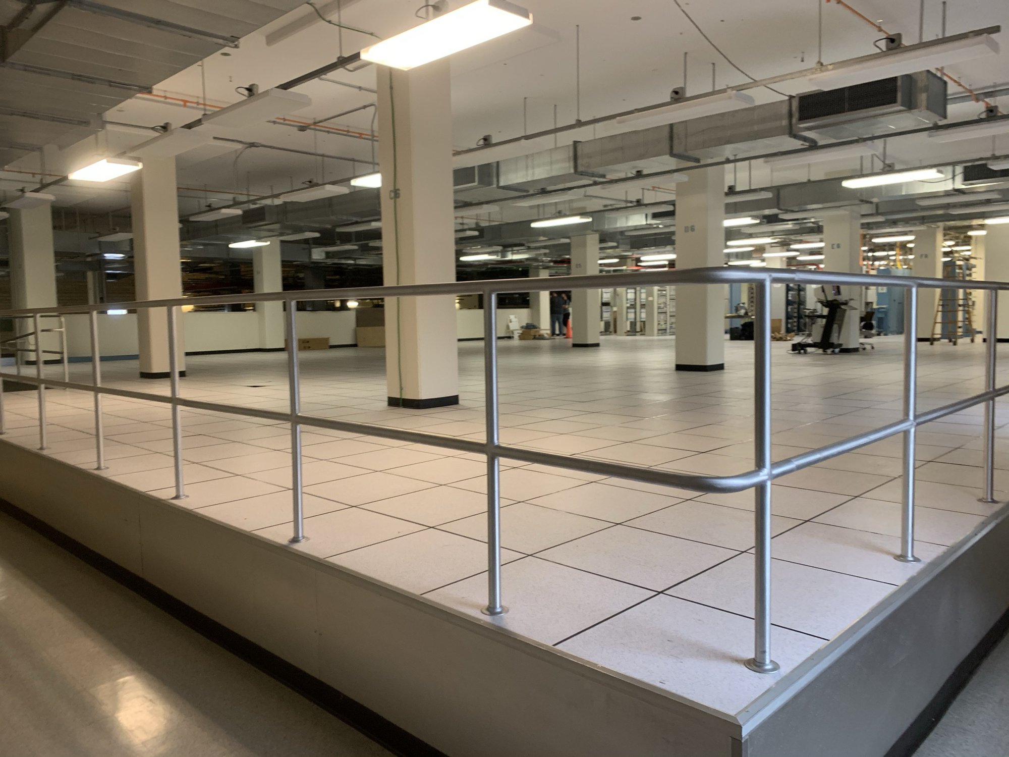 a large room with a metal railing