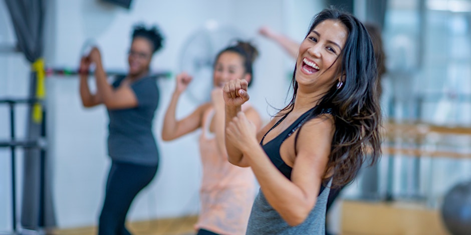 a group of women dancing in a gym