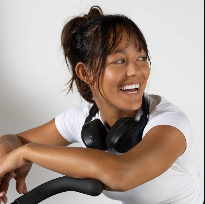 a woman with headphones on her neck