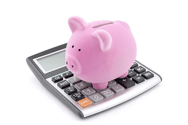 a pink piggy bank on a calculator
