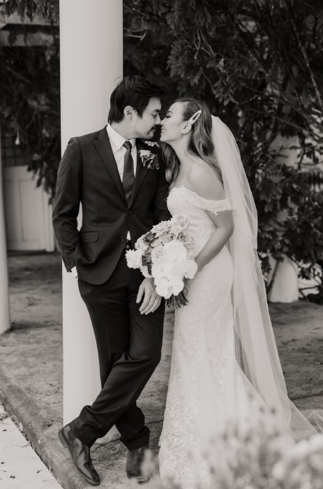 a man and woman in wedding attire kissing