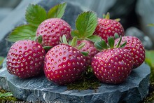 a group of strawberries on a rock