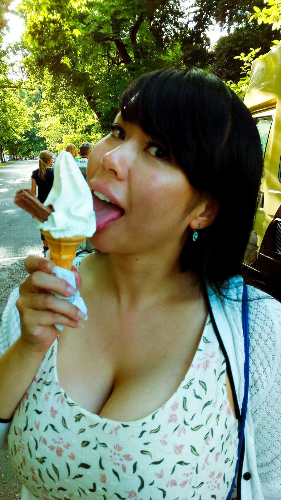 a woman licking an ice cream cone
