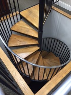 a spiral staircase with a metal railing