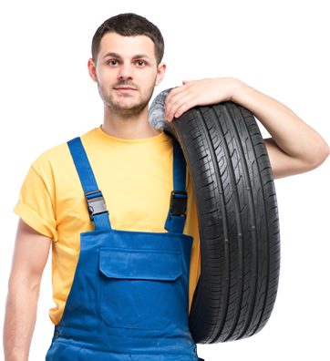 a man in overalls holding a tire